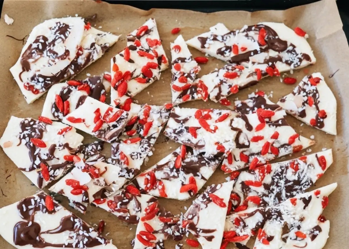 tall tray of coconut yogurt bark with chocolate swirls and goji berries