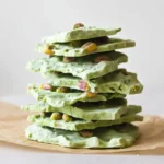 Matcha Yogurt Bark – Frozen Greek Yogurt & Pistachio 2 Overhead sheet of matcha yogurt bark with chopped pistachios pressed in