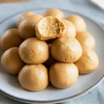 Overhead tray of 3-ingredient peanut butter balls (no bake) on parchment